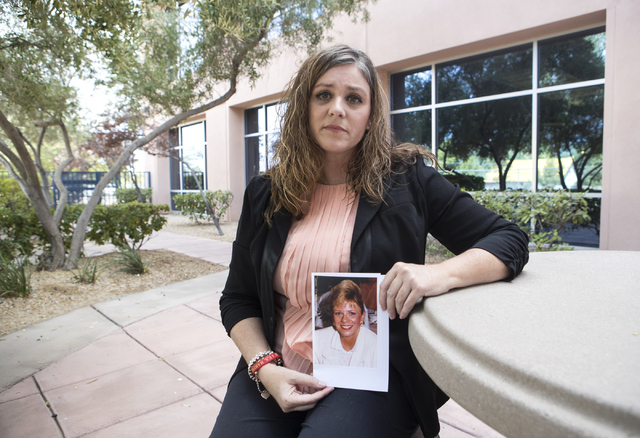 Michelle Perkins, daughter of Jan Sites, holds up a picture of her mother outside the Nevada Parole Board office in Las Vegas on Wednesday, Sept. 21, 2016. Sites was murdered by her husband, Willi ...