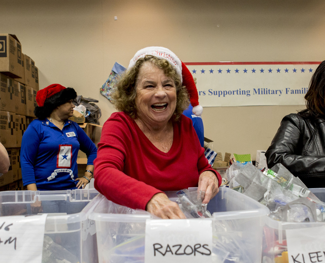 Sandi Athey, a volunteer during the 8th annual &quot;Stockings for our Troops,&quot; fills bags with razors  to be placed in stockings that will be sent to troops overseas, Henderson City  ...
