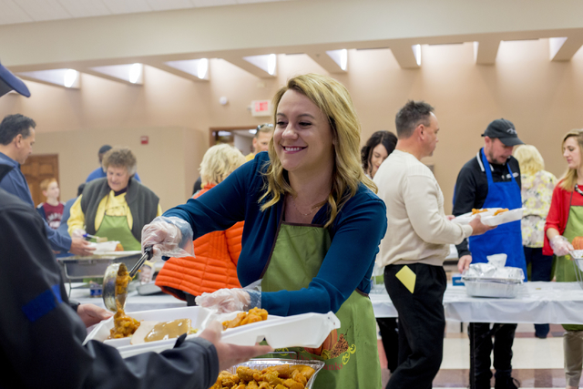 Sydney Sears, a volunteer and member of St. Thomas More, dishes food to be delivered to seniors on Thanksgiving, at St. Thomas More Catholic Community in Henderson, Thursday, Nov. 24, 2016, Las Ve ...
