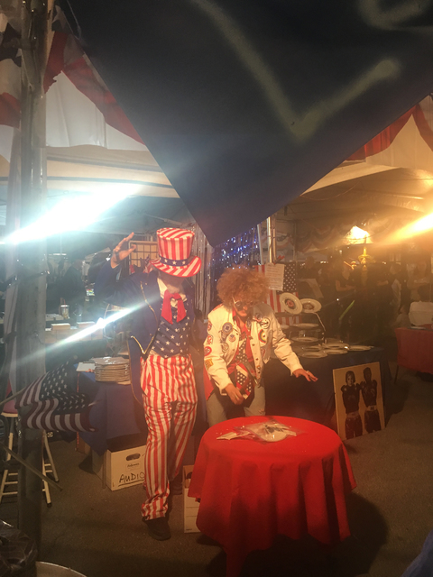 Uncle Sam (alias artist Stewart Freshwater) and artist Diane Bush show October First Friday attendees how to "Let America Break Again" as part of the satirical "Dishing It Out" art project Bush or ...
