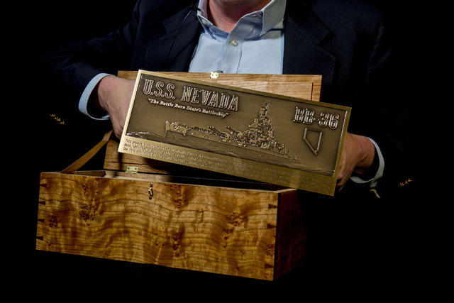 John Galloway, pilot and USS Nevada historian, holds a plaque that will be displayed in Pearl H ...