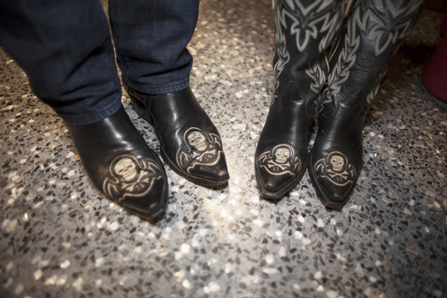 Greg McKinney and his wife Kelly wear matching skull and crossbones boots at the National Final ...