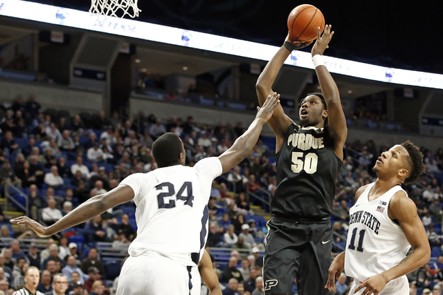 Purdue's Caleb Swanigan (50) shoots between Penn State's Mike Watkins (24) and Lamar Stevens during the second half of an NCAA college basketball game in State College, Pa., Tuesday, Feb. 21, 2017 ...