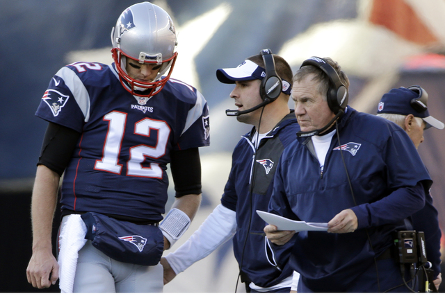 New England Patriots quarterback Tom Brady (12) listens to offensive coordinator Josh McDaniels, middle, and head coach Bill Belichick during the first half of an NFL football game against the Los ...