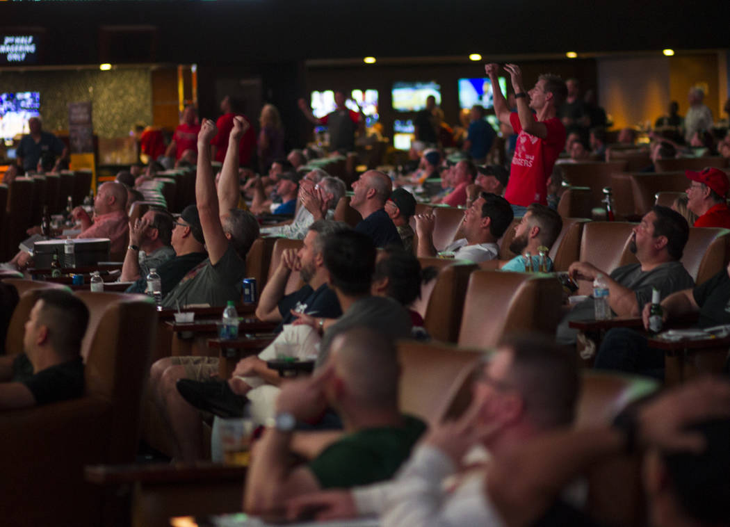 Basketball fans react as Northwestern defeats Vanderbilt during the first day of the NCAA basketball tournament at the Westgate sports book in Las Vegas on Thursday, March 16, 2017. (Chase Stevens ...