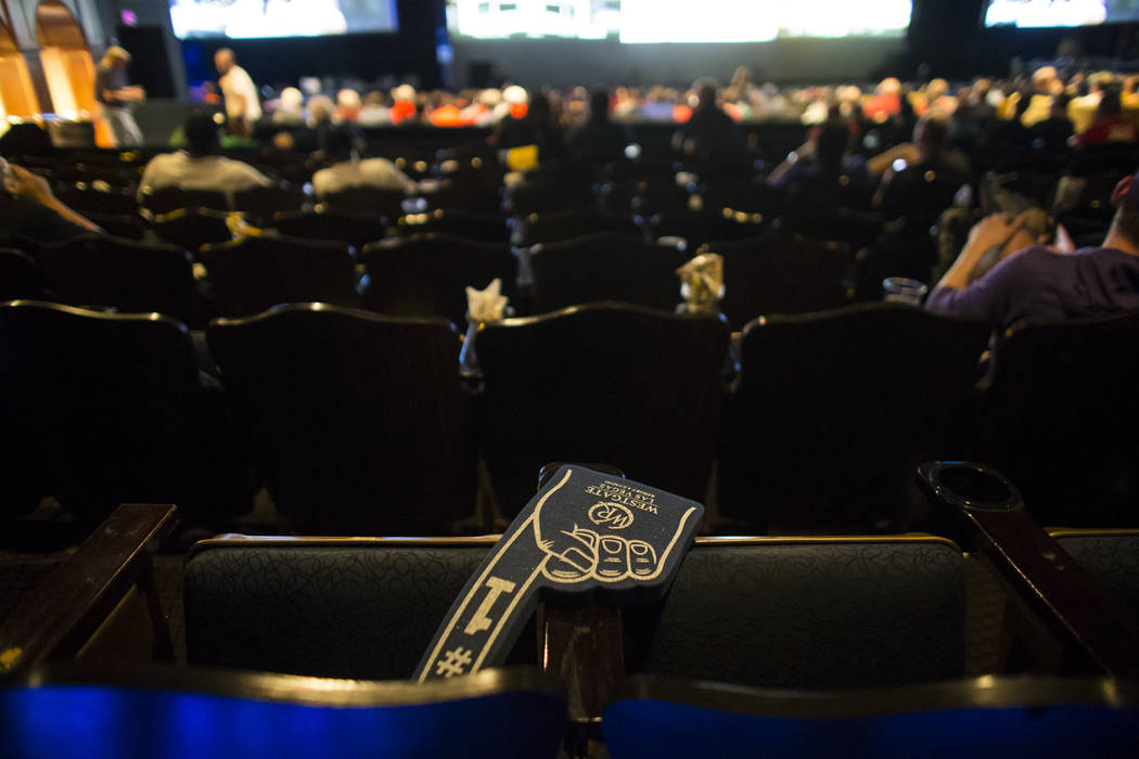 A foam finger is left behind as basketball fans watch the action during the first day of the NCAA basketball tournament at the International Westgate Theater in Las Vegas on Thursday, March 16, 20 ...