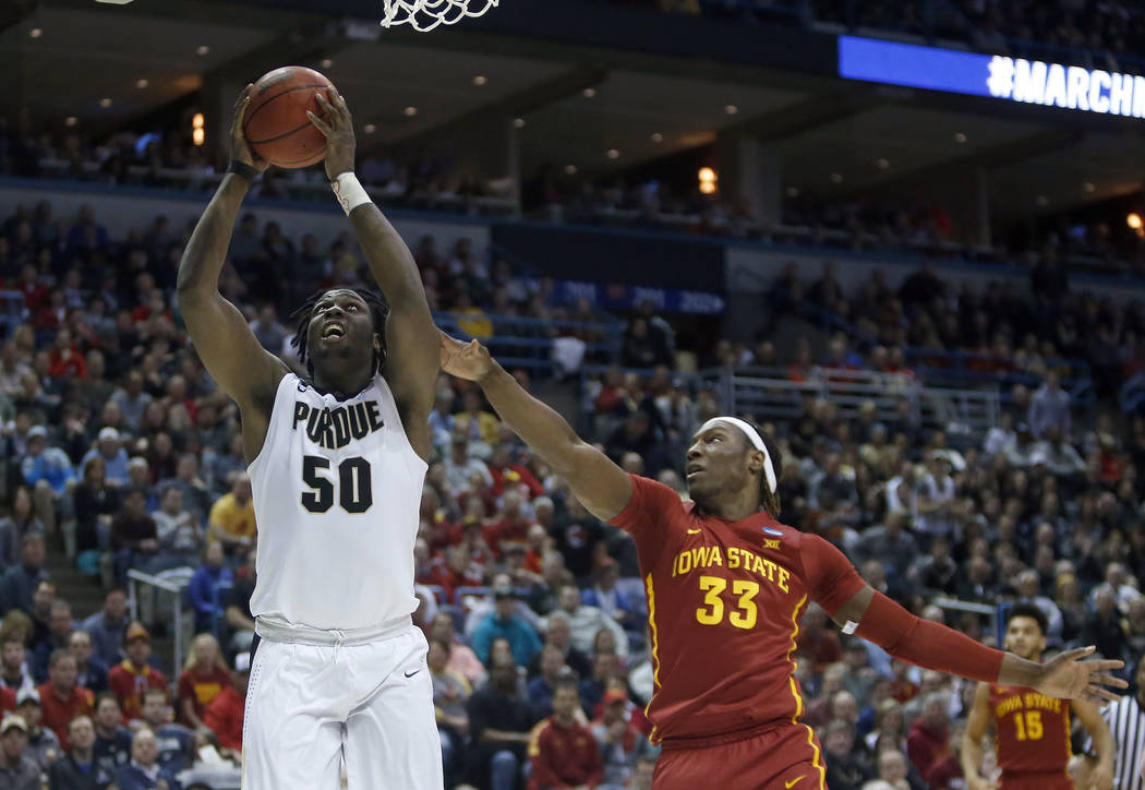 Purdue's Caleb Swanigan (50) goes up for a basket against Iowa State's Solomon Young (33) during the first half of an NCAA college basketball tournament second-round game Saturday, March 18, 2017, ...