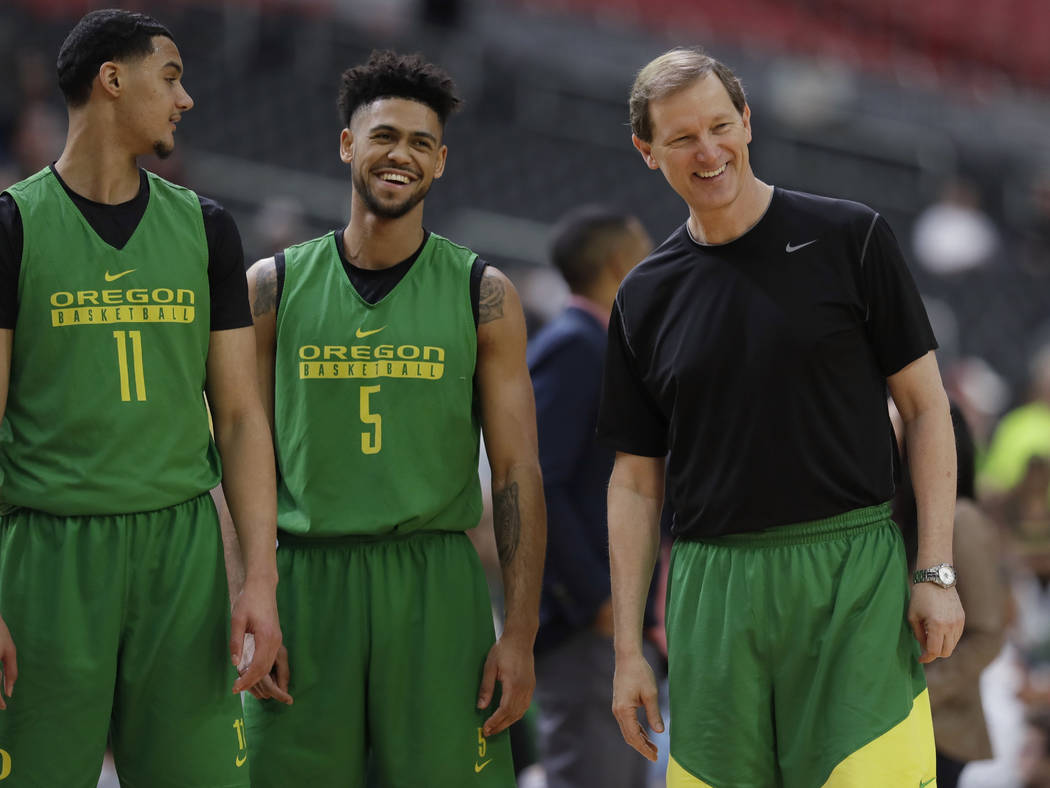 Oregon head coach Dana Altman laughs with Keith Smith (11) and Tyler Dorsey (5) during a practice session for their NCAA Final Four tournament college basketball semifinal game Friday, March 31, 2 ...