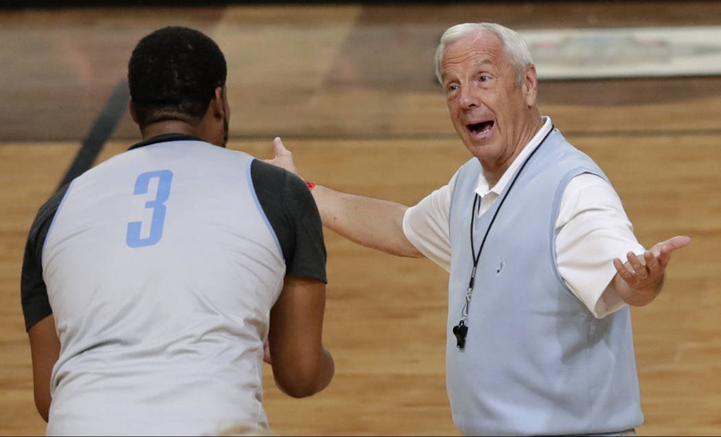 North Carolina head coach Roy Williams, right, talks with forward Kennedy Meeks during a practice session for their NCAA Final Four tournament college basketball semifinal game Friday, March 31, 2 ...