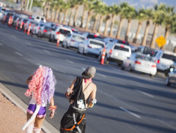 Electric Daisy Carnival revealers walk along Speedway Boulevard on Monday, June 22, 2015. The three-day EDC festival ended on Monday morning. Follow Jeff Scheid on Twitter @jlscheid (Jeff Scheid/L ...