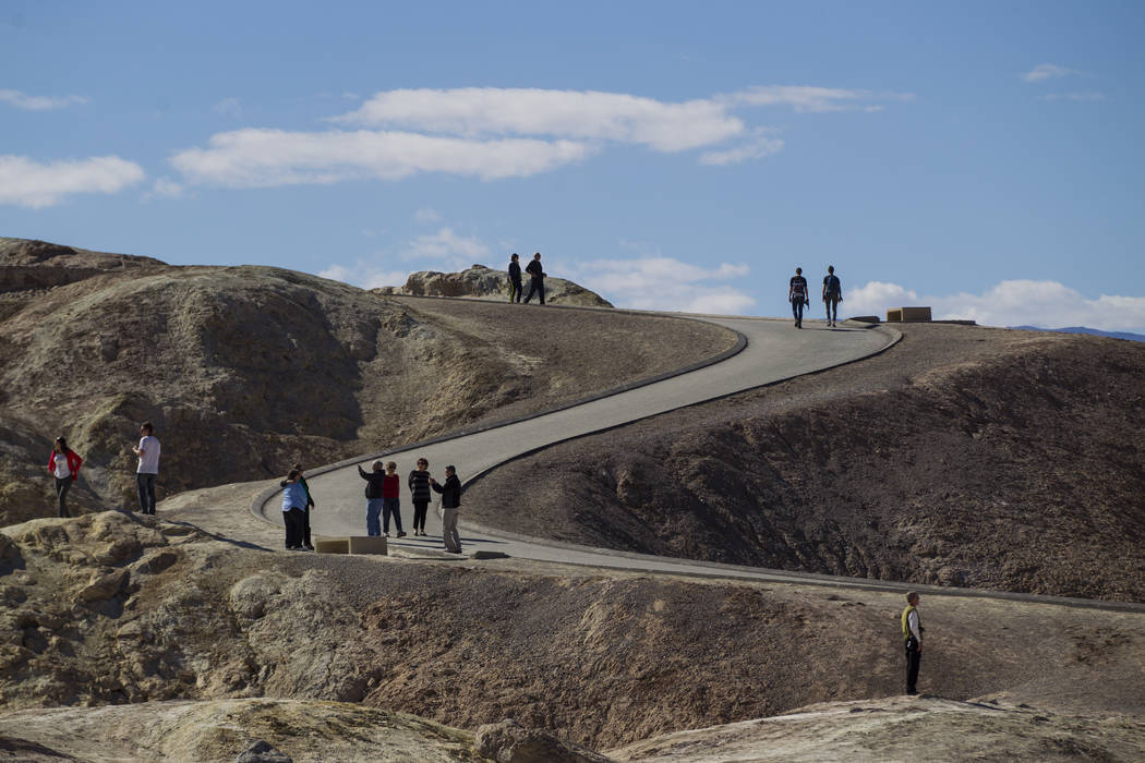 People at Zabriskie Point in Death Valley National Park on Tuesday, Feb. 28, 2017. The cover ar ...