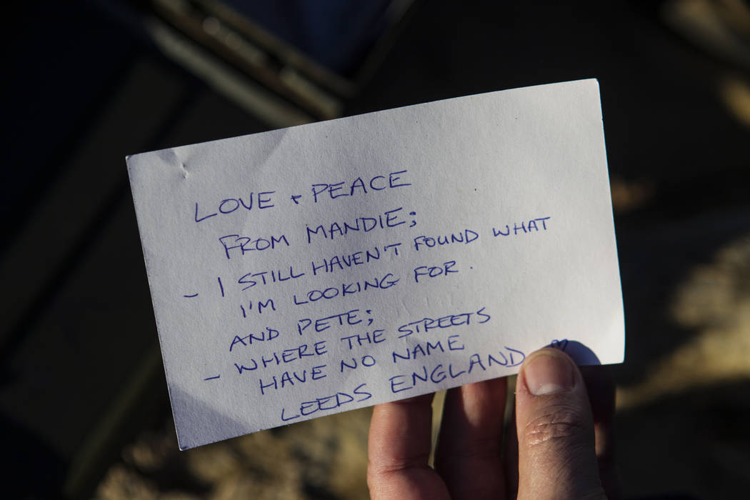 A note left by a fan of rock band U2 sits with the fallen tree that appeared in the band's 1987 ...