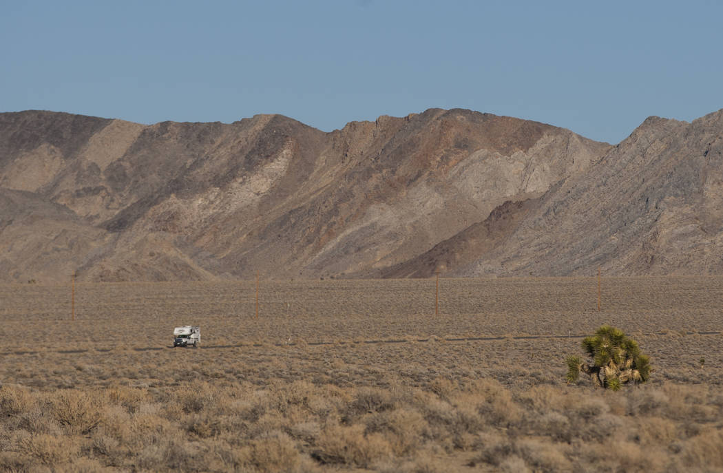 An RV drives along California State Route 190 outside of Death Valley National Park, seen from ...