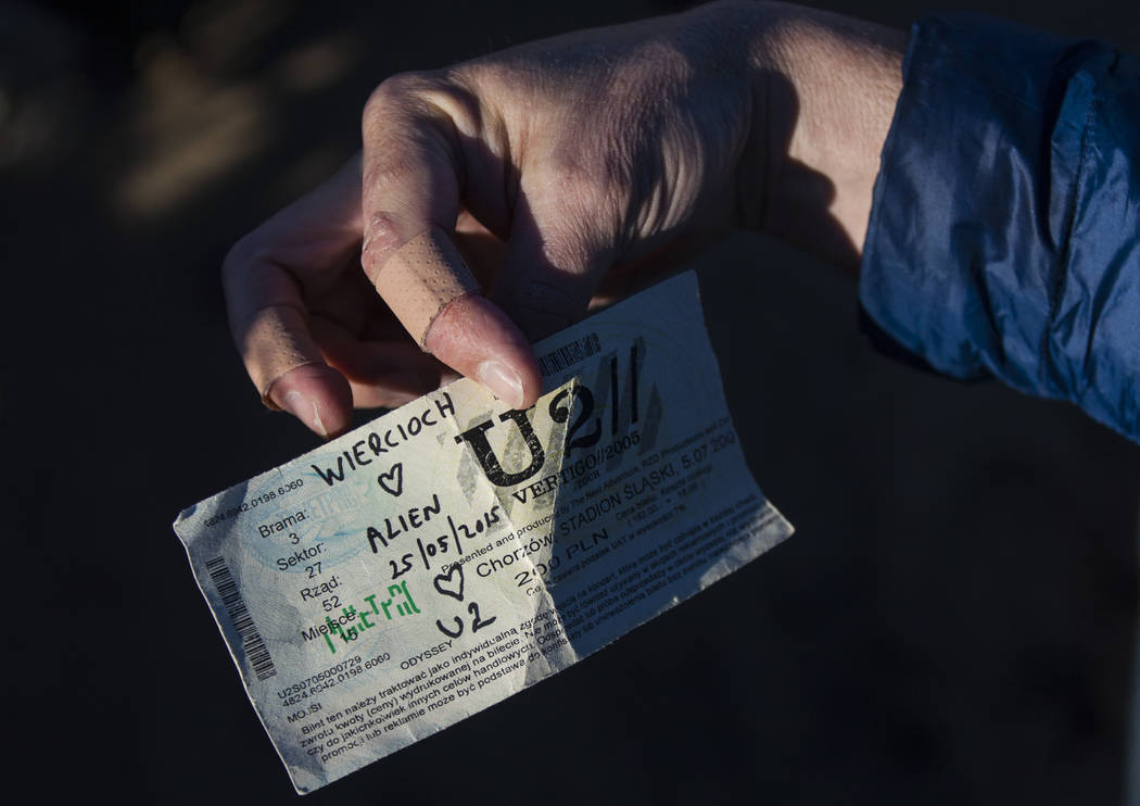 An old concert ticket left by fans of rock band U2 sits with the fallen tree that appeared in t ...