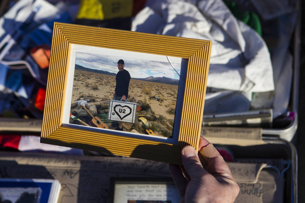 A photo left by fans of rock band U2 sits with the fallen tree that appeared in the band's 1987 ...