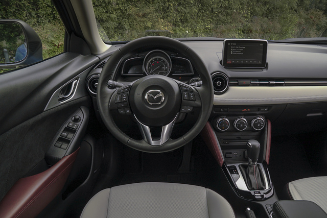 COURTESY MAZDA
The control panel of the Mazda CX-3 includes a trio of oversized knobs and a dashboard gauge pod flanked by twin info screens.