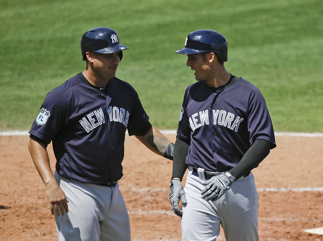 New York Yankees' Greg Bird, right, celebrates with Gary Sanchez after Bird hit a two-run home run in the fourth inning against the Philadelphia Phillies in a spring training baseball game, Wednes ...