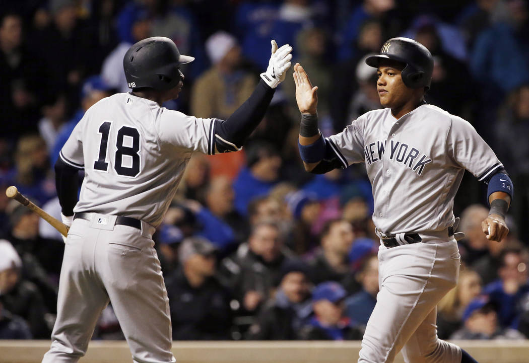 New York Yankees' Starlin Castro, right, celebrates with Didi Gregorius after scoring on a triple by Aaron Judge during the seventh inning of a baseball game against the Chicago Cubs, Sunday, May  ...