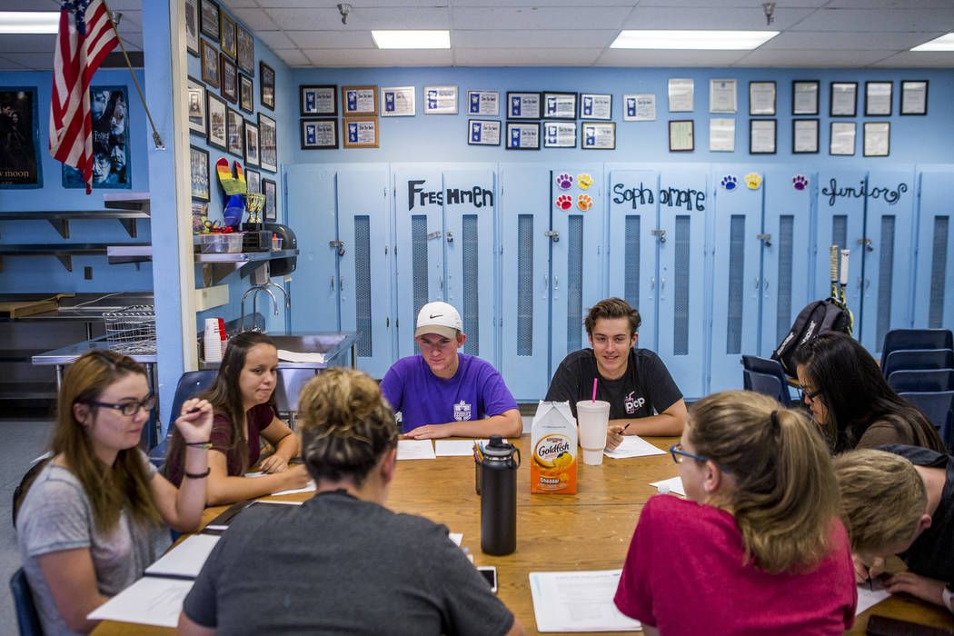 Student council members including Devon Neary, secretary, left, Maya Duckworth, sophomore class president, Justin Balconi, student body president, and James Mead, second vice president, work throu ...