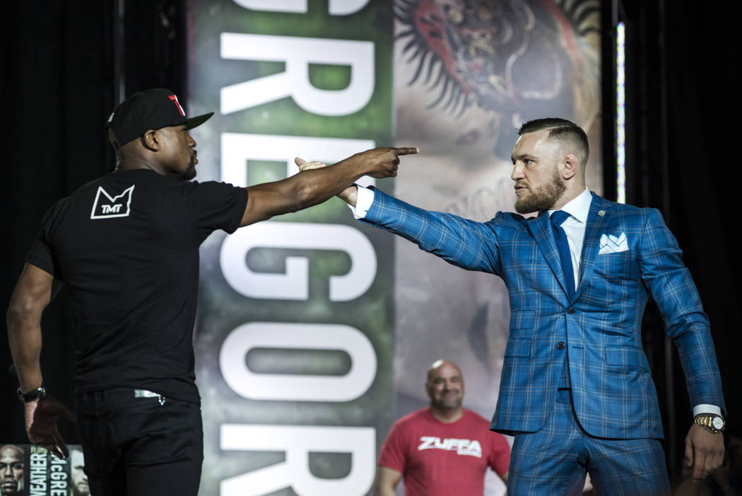 Floyd Mayweather, left, and Conor McGregor exchange harsh words during a promotional stop in Toronto on Wednesday, July 12, 2017, for their upcoming boxing match in Las Vegas. (Christopher Katsaro ...