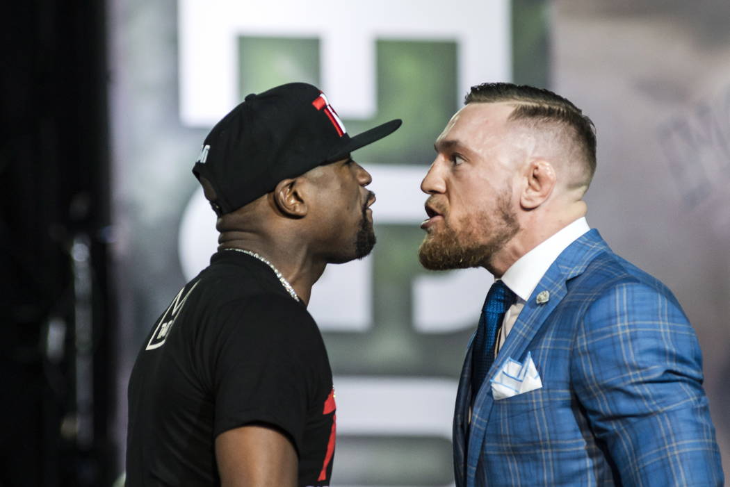 Floyd Mayweather, left, and Conor McGregor exchange harsh words during a promotional stop in Toronto on Wednesday, July 12, 2017, for their upcoming boxing match in Las Vegas. (Christopher Katsaro ...