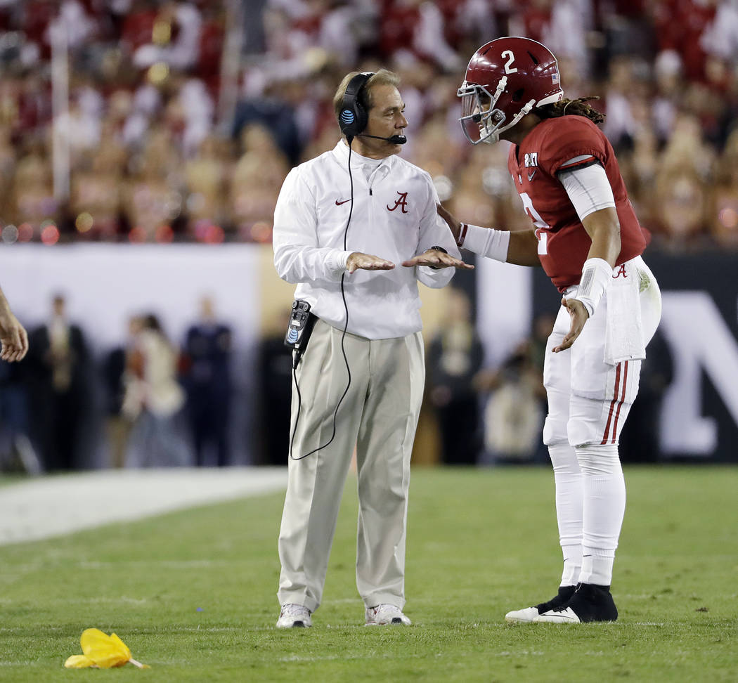 Alabama head coach Nick Saban talks to Jalen Hurts during the first half of the NCAA college football playoff championship game against Clemson Monday, Jan. 9, 2017, in Tampa, Fla. (AP Photo/David ...