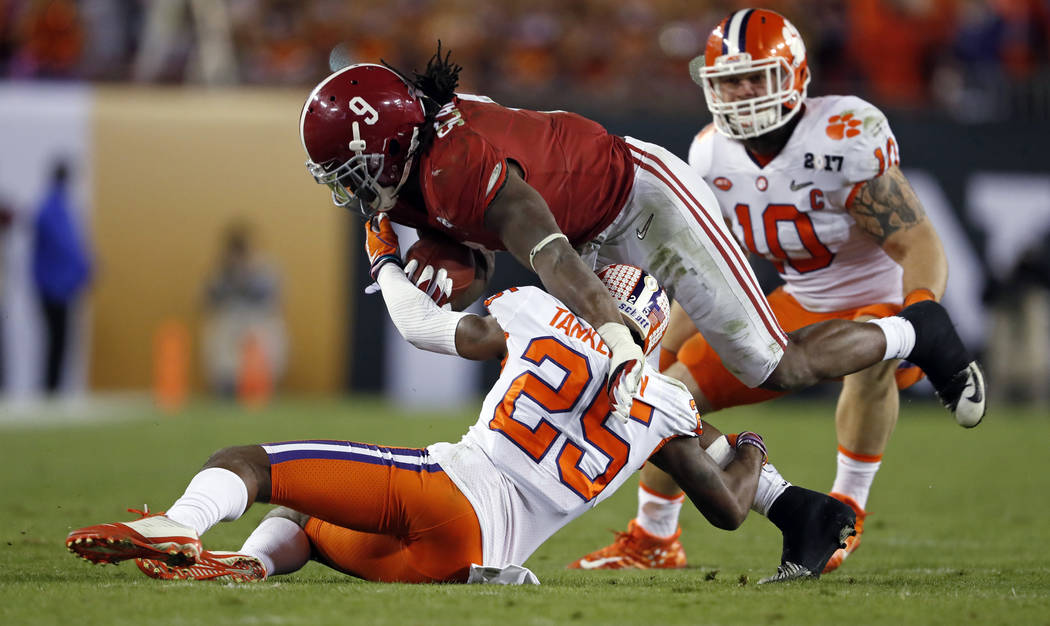 Alabama's Bo Scarbrough is stopped by Clemson's Cordrea Tankersley* during the second half of the NCAA college football playoff championship game Monday, Jan. 9, 2017, in Tampa, Fla. (AP Photo/Joh ...