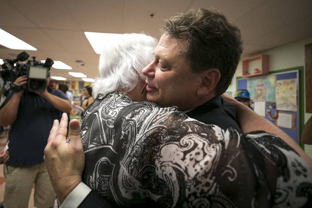 Clark County School District Superintendent Pat Skorkowsky, left, hugs CCSD Board of Trustees member Carolyn Edwards after announcing his retirement during a press conference held at Walter Bracke ...