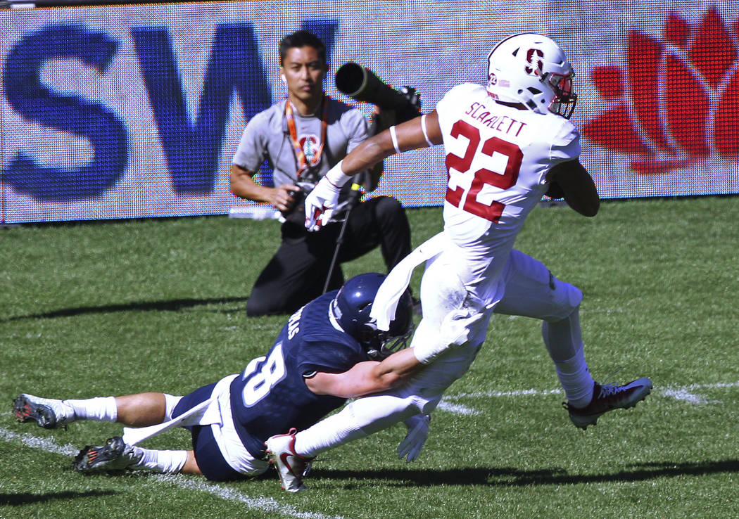 Stanford's running back Cameron Scarlett, right, breaks the tackle from Rice's safety Cole Thomas during the opening game of the U.S. college football season in Sydney, Sunday, Aug. 27, 2017. (AP  ...