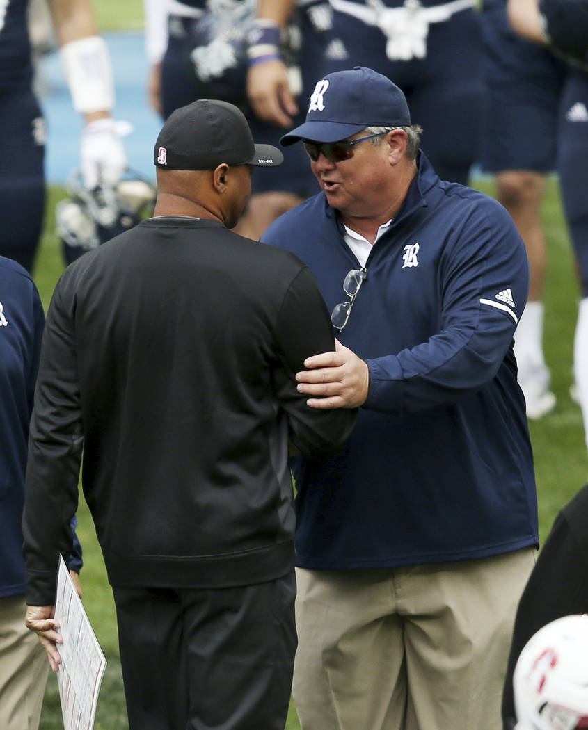 Stanford's head coach David Shaw, left, shakes hands with Rice's head coach David Bailiff at the end of their U.S. college football game in Sydney, Sunday, Aug. 27, 2017. (AP Photo/Rick Rycroft)