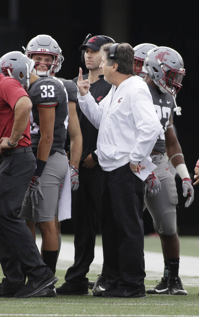 Washington State head coach Mike Leach, center, speaks to his team during the second half of an NCAA college football game against Oregon State in Pullman, Wash., Saturday, Sept. 16, 2017. (AP Pho ...