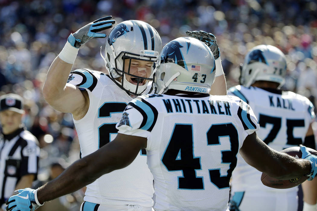 Carolina Panthers running back Fozzy Whittaker, foreground, celebrates his touchdown against the New England Patriots with Christian McCaffrey, left, during the first half of an NFL football game, ...