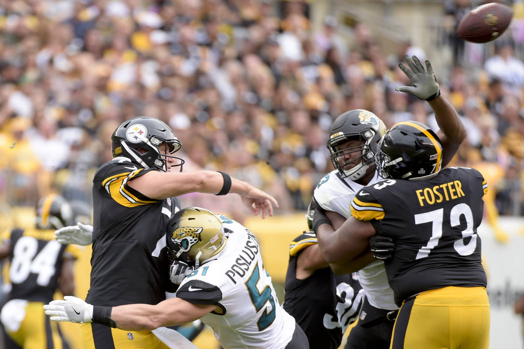Pittsburgh Steelers quarterback Ben Roethlisberger (7) gets a pass away as he is hit by Jacksonville Jaguars middle linebacker Paul Posluszny (51) in the first half of an NFL football game, Sunday ...