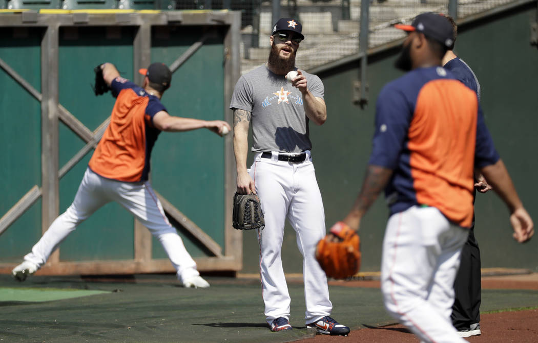 Houston Astros starting pitcher Dallas Keuchel warms up during practice Wednesday, Oct. 11, 2017, in Houston. The Astros beat the Red Sox to advance to the ALCS which is set to begin Friday. (AP P ...
