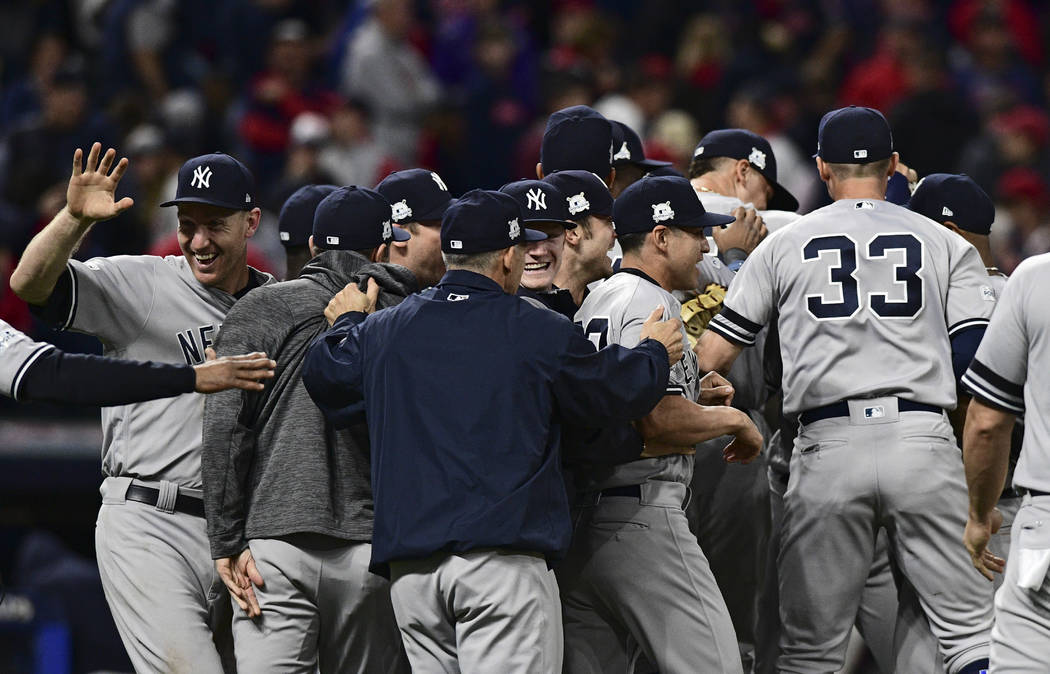 New York Yankees celebrate after the Yankees defeated the Cleveland Indians 5-2 in Game 5 of s baseball American League Division Series, Wednesday, Oct. 11, 2017, in Cleveland, to advance to the A ...