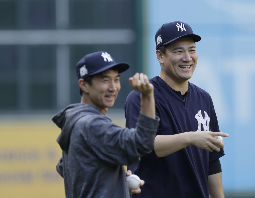 New York Yankees' Masahiro Tanaka smiles during batting practice for Game 1 of the American League Championship Series against the Houston Astros baseball game Thursday, Oct. 12, 2017, in Houston. ...