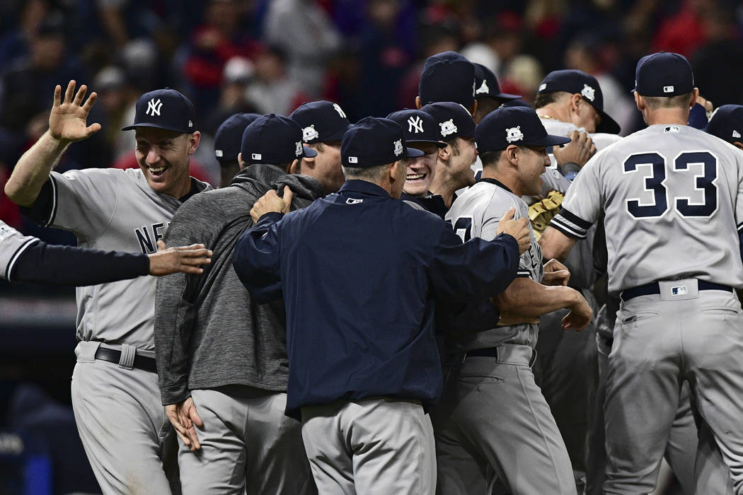 New York Yankees celebrate after the Yankees defeated the Cleveland Indians 5-2 in Game 5 of s baseball American League Division Series, Wednesday, Oct. 11, 2017, in Cleveland, to advance to the A ...