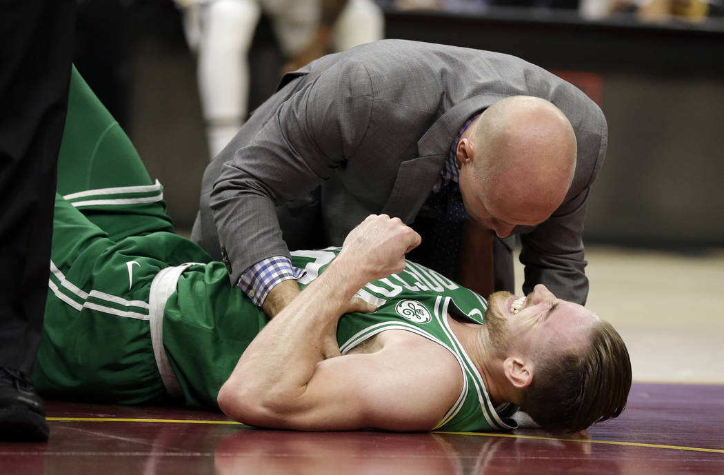 Boston Celtics' Gordon Hayward grimaces in pain in the first half of an NBA basketball game against the Cleveland Cavaliers, Tuesday, Oct. 17, 2017, in Cleveland. Just five minutes into his Boston ...