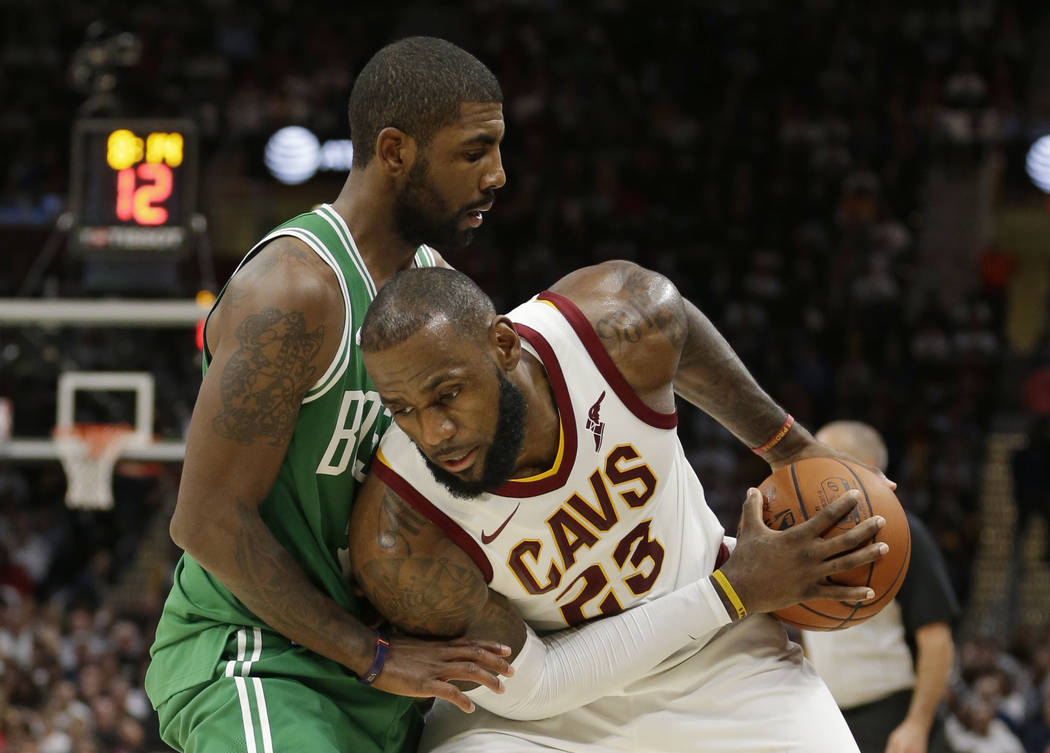 Cleveland Cavaliers' LeBron James, right, tries to get past Boston Celtics' Kyrie Irving in the second half of an NBA basketball game, Tuesday, Oct. 17, 2017, in Cleveland. The Cavaliers won 102-9 ...
