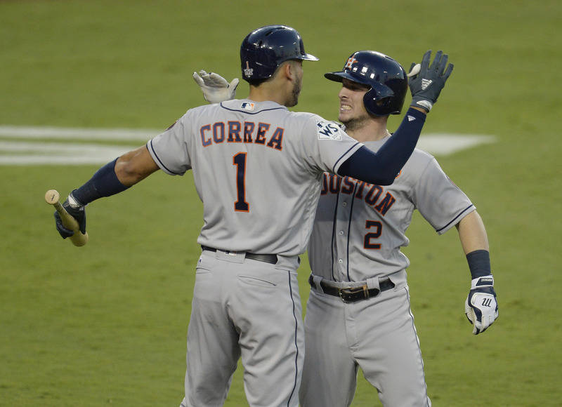 Oct 24, 2017; Los Angeles, CA, USA; Houston Astros third baseman Alex Bregman (2) celebrates with shortstop Carlos Correa (1) after hitting a solo home run in the fourth inning in game one of the  ...