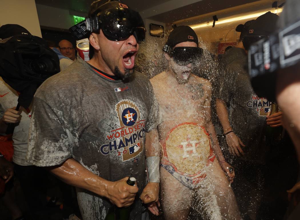 Houston Astros' Josh Reddick and Javier Bracamonte celebrate after Game 7 of baseball's World Series against the Los Angeles Dodgers Wednesday, Nov. 1, 2017, in Los Angeles. The Astros won 5-1 to  ...