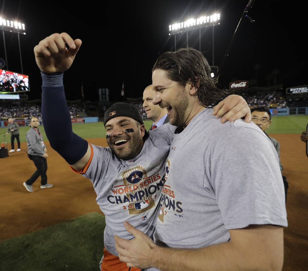 Houston Astros' Jose Altuve and Jake Marisnick celebrate after Game 7 of baseball's World Series against the Los Angeles Dodgers Wednesday, Nov. 1, 2017, in Los Angeles. The Astros won 5-1 to win  ...