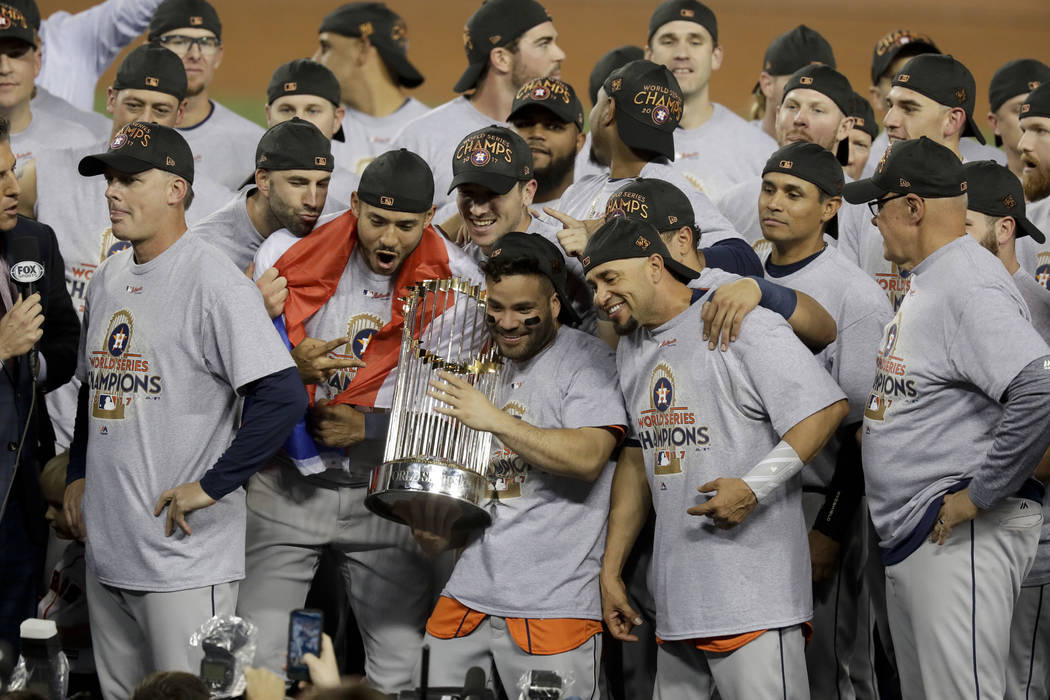 The Houston Astros celebrate with the trophy after their win against the Los Angeles Dodgers in Game 7 of baseball's World Series Wednesday, Nov. 1, 2017, in Los Angeles. The Astros won 5-1 to win ...