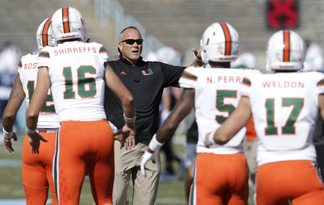 Miami head coach Mark Richt watches his team warm up prior to an NCAA college football game against North Carolina in Chapel Hill, N.C., Saturday, Oct. 28, 2017. (AP Photo/Gerry Broome)