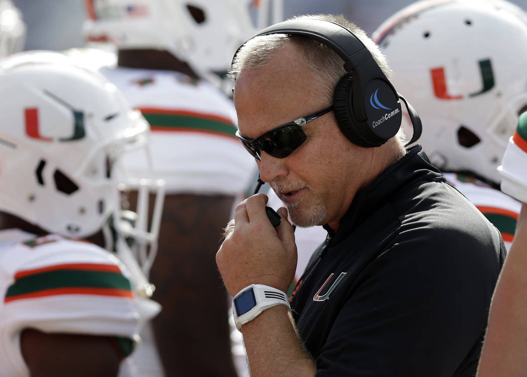 FILE - In this Saturday, Oct. 28, 2017, file photo, Miami head coach Mark Richt speaks into his headset during the first half of an NCAA college football game against North Carolina in Chapel Hill ...