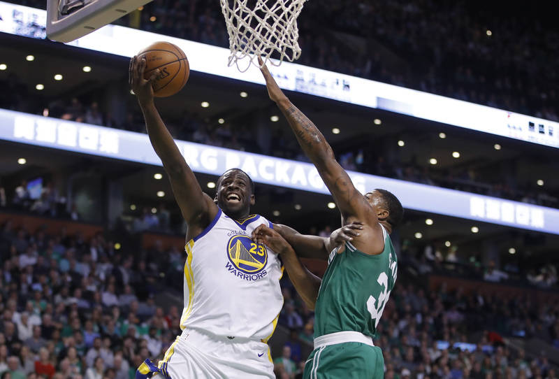 Nov 16, 2017; Boston, MA, USA; Golden State Warriors forward Draymond Green (23) drives to the basket as Boston Celtics guard Marcus Smart (36) defends in the second quarter at TD Garden. Mandator ...
