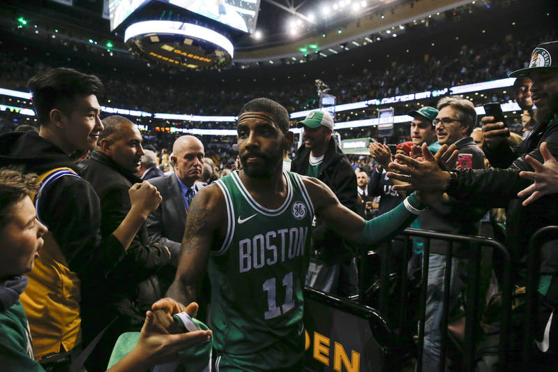 Nov 16, 2017; Boston, MA, USA; Boston Celtics guard Kyrie Irving (11) celebrates with fans while leaving the court after defeating the Golden State Warriors 92-88 at TD Garden. Mandatory Credit: D ...