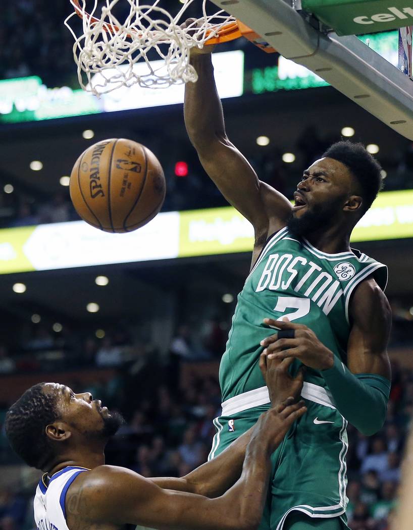 Boston Celtics' Jaylen Brown (7) dunks over Golden State Warriors' Kevin Durant during the first quarter of an NBA basketball game in Boston, Thursday, Nov. 16, 2017. (AP Photo/Michael Dwyer)