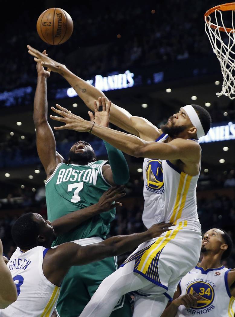 Boston Celtics' Jaylen Brown (7) battles Golden State Warriors' JaVale McGee (1) for a rebound during the first quarter of an NBA basketball game in Boston, Thursday, Nov. 16, 2017. (AP Photo/Mich ...