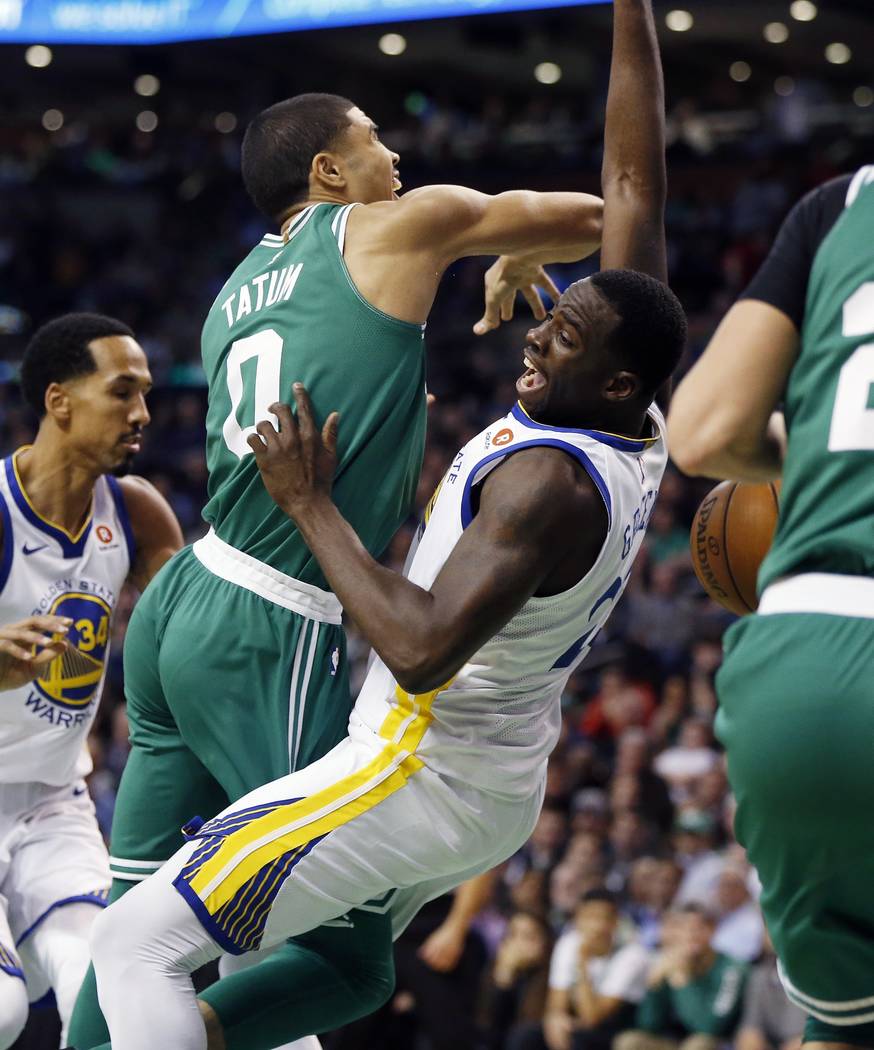 Golden State Warriors' Draymond Green, right, fouls Boston Celtics' Jayson Tatum, left, during the second quarter of an NBA basketball game in Boston, Thursday, Nov. 16, 2017. (AP Photo/Michael Dwyer)